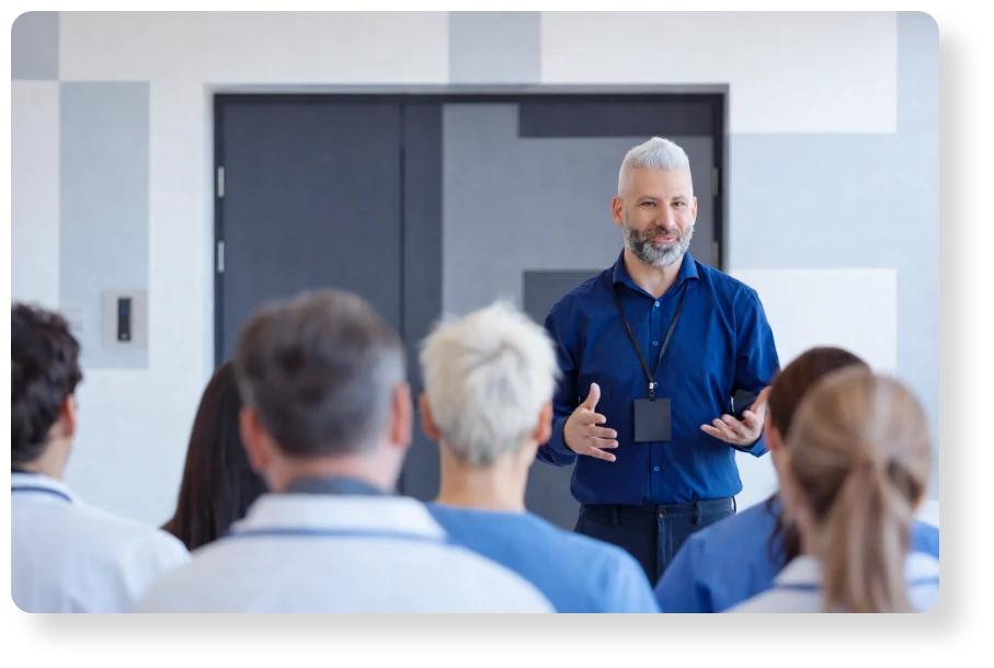 Business professional leading a team presentation and speaking to colleagues during a meeting.